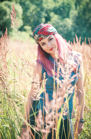 Beautiful woman in boho style enjoy sunlight outdoorの写真素材