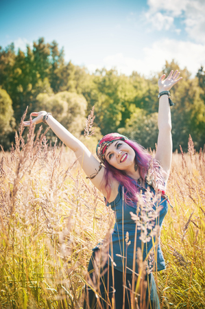 Beautiful woman in boho style enjoy sunlight outdoorの写真素材