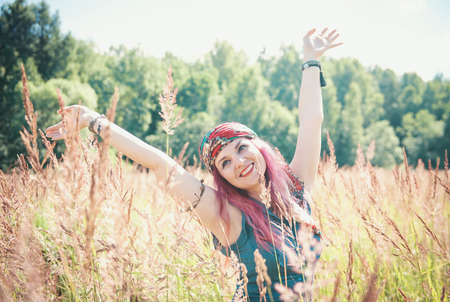 Beautiful woman in boho style enjoy sunlight outdoorの写真素材
