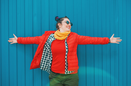 Young beautiful fashion hipster woman with colorful hair over blue background