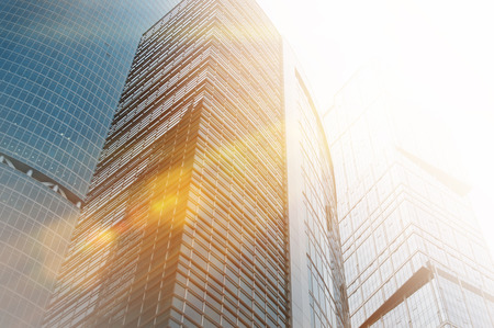 Modern business skyscrapers buildings of glass with sunlight effect