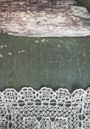 Vintage background with lace tablecloth on the old woodの写真素材