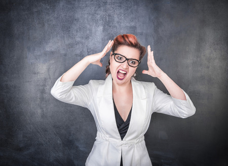 Angry screaming woman on the chalkboard blackboard backgroundの写真素材