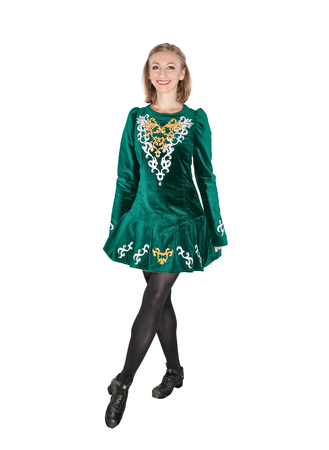 Beautiful young woman in Irish dance green dress isolated on whiteの写真素材