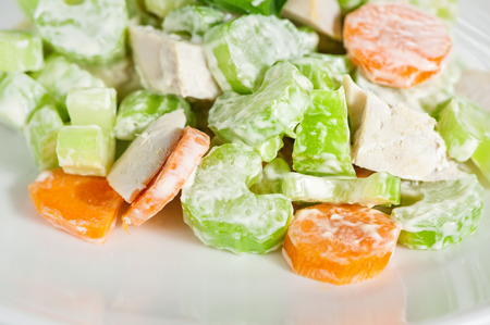 Fresh delicious healthy salad with celery, carrot and meat on white backgroundの写真素材