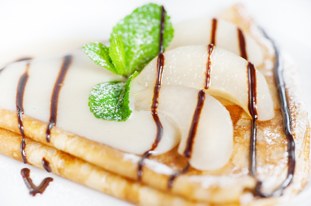 Thin delicious pancake with condensed milk on white backgroundの写真素材