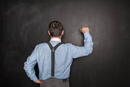 Business man knock by fist on blackboard background. Opportunity conceptの写真素材