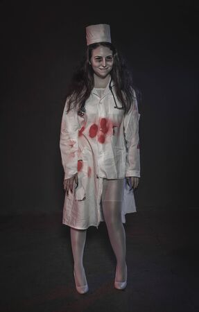 Terrible nurse woman smiling. Halloween horror scene