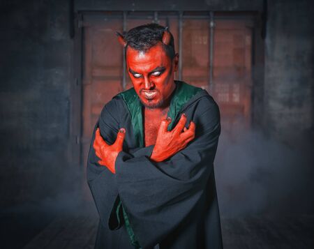 Terrible devil man with red skin. Scary Halloween scene