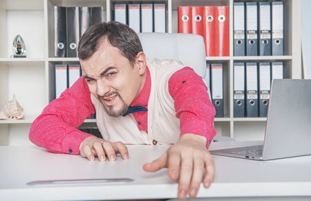 Tired business man working in office and wants to escape. Overwork conceptの写真素材