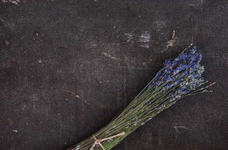 Beautiful dry lavender flowers on the rustic material backgroundの写真素材