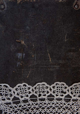 Old vintage lace fabric on the rustic material backgroundの写真素材