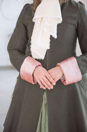 Hands of woman in beautiful vintage medieval dress frock-coatの写真素材