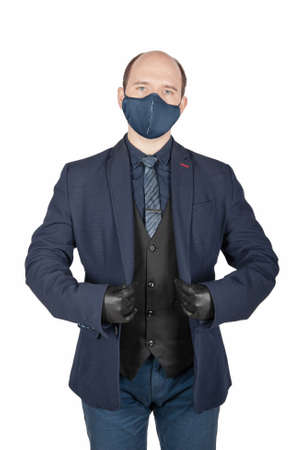 Handsome young business man with black gloves and surgical medical virus protection mask on his face...