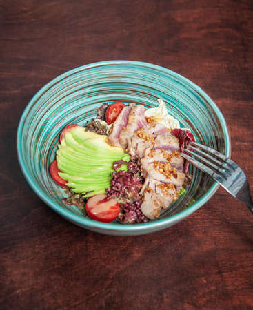 Fresh fry meat with vegetables and green avocado in the plateの写真素材