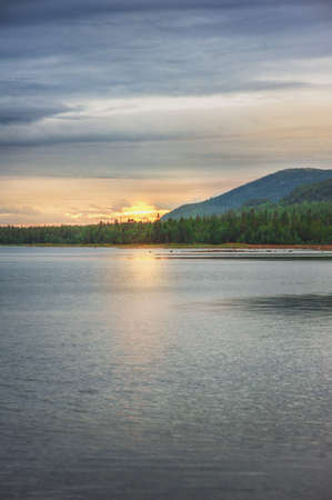 Beautiful gloomy landscape with lake and hills rangeの写真素材