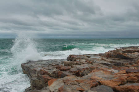 Dramatic scene with Sea waves crashing on big rocks