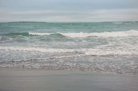 Beautiful dramatic blue sea waves and gloomy sky