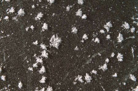 Texture of frozen ice surface with snow. Winter background for designの写真素材