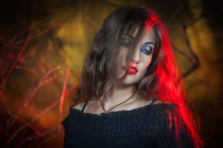 Beautiful sexy woman with long hair. halloween scene