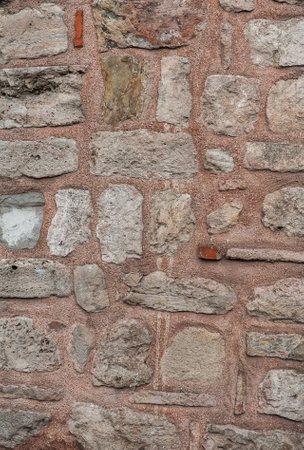Grunge wall background with old weathered stones texture