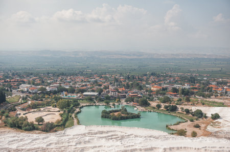 Beautiful landscape with white calcium travertine terraces, blue pond and sky in Pamukkale, Turkeyの写真素材