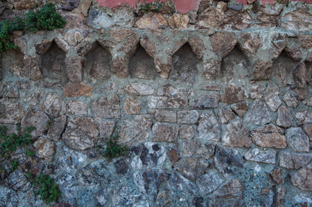 Grunge medieval wall background with old weathered stones textureの写真素材