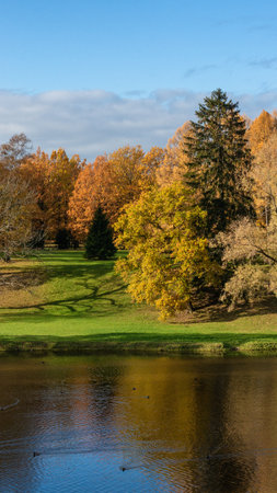 Beautiful sunny colorful forest autumn landscape. Amazing park with lakeの写真素材
