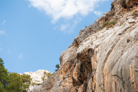 Majestic rocky cliff against a bright sky, showcasing rugged natural beautyの写真素材