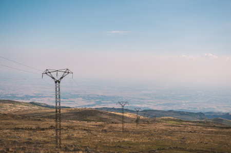 Powerlines stretch across the rural Armenian landscape, blending technology with nature