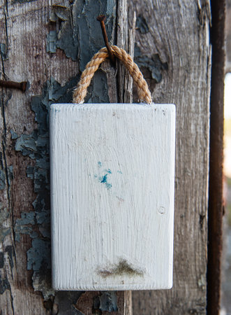 Old wooden blank signboard on the old aged wooden wall backgroundの写真素材