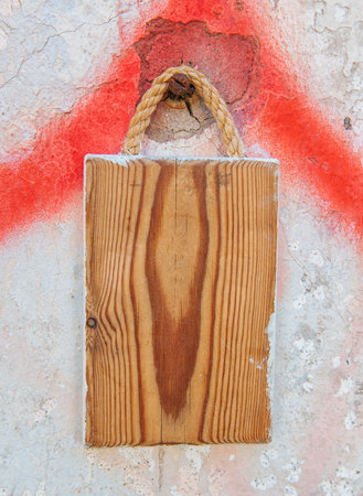 Old wooden blank signboard on the old aged wall backgroundの写真素材