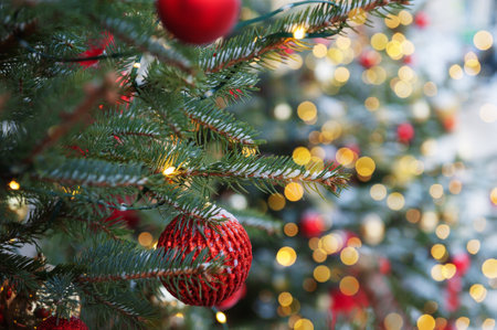 Festive pine tree decoration captured with a cozy, bokeh-filled background. Christmas backgroundの写真素材