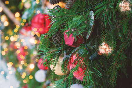 Festive pine tree decoration captured with a cozy, bokeh-filled background. Christmas backgroundの写真素材