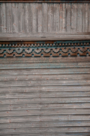 Weathered wooden panel with ornate carving details, perfect for rustic vintage design or heritage architecture themesの写真素材