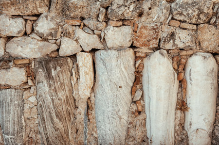 Weathered stone wall background with marble details showcases ancient craftsmanshipの写真素材