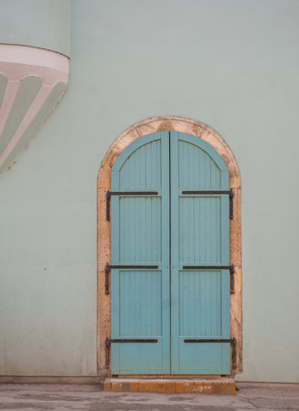Old decorative main entrance wooden vintage door with blue wallの写真素材