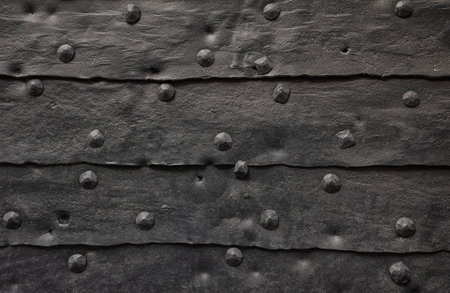 Worn aged metal sheets with rivets creates a textured industrial backgroundの写真素材