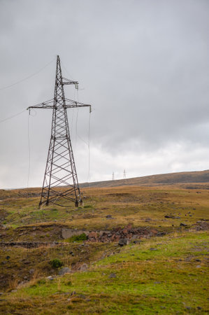 Rusty power pylon standing alone in a remote countryside landscapeの写真素材