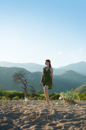 Stylish beautiful woman standing barefoot in nature captures serenity and adventureの写真素材