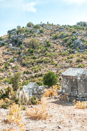 Ancient old ruined tombs on sunny day against cloudy sky in Turkeyの写真素材