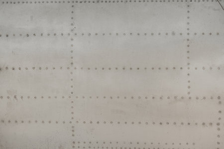 Metal aircraft surface texture of vintage aviation design with aged rivets and industrial patternの写真素材
