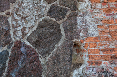 Rustic stone wall showing rough granite textures and solid construction. Natural masonry patternの写真素材