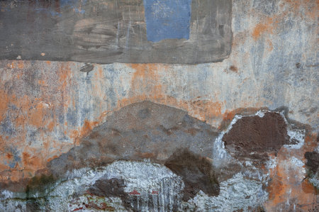 Cracked vintage wall with textured surface, spots and rustic charmの写真素材