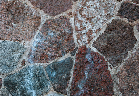 Rustic stone wall showing rough granite textures and solid construction. Natural masonry patternの写真素材