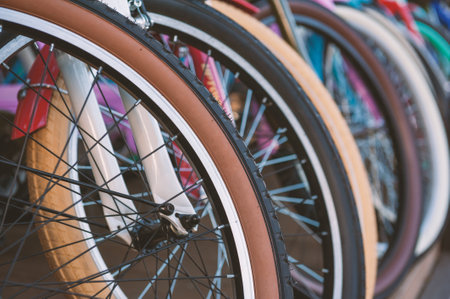 Colorful bicycle wheels in perfect alignment highlight urban mobility and ecofriendly lifestyleの写真素材