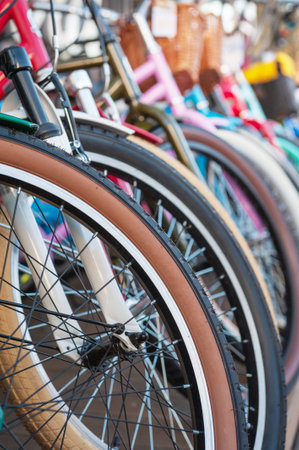 Colorful bicycle wheels in perfect alignment highlight urban mobility and ecofriendly lifestyleの写真素材