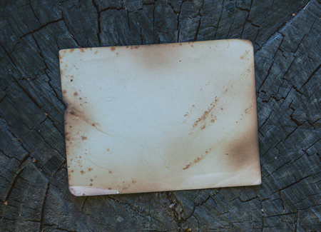 Vintage empty paper lies on the old wooden texture backgroundの写真素材