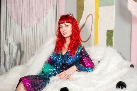 Glamor portrait of woman with red hair in sparkling sequin dress and elegance against modern...