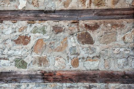 Rustic stone texture shows rugged masonry with weathered structure detailの写真素材